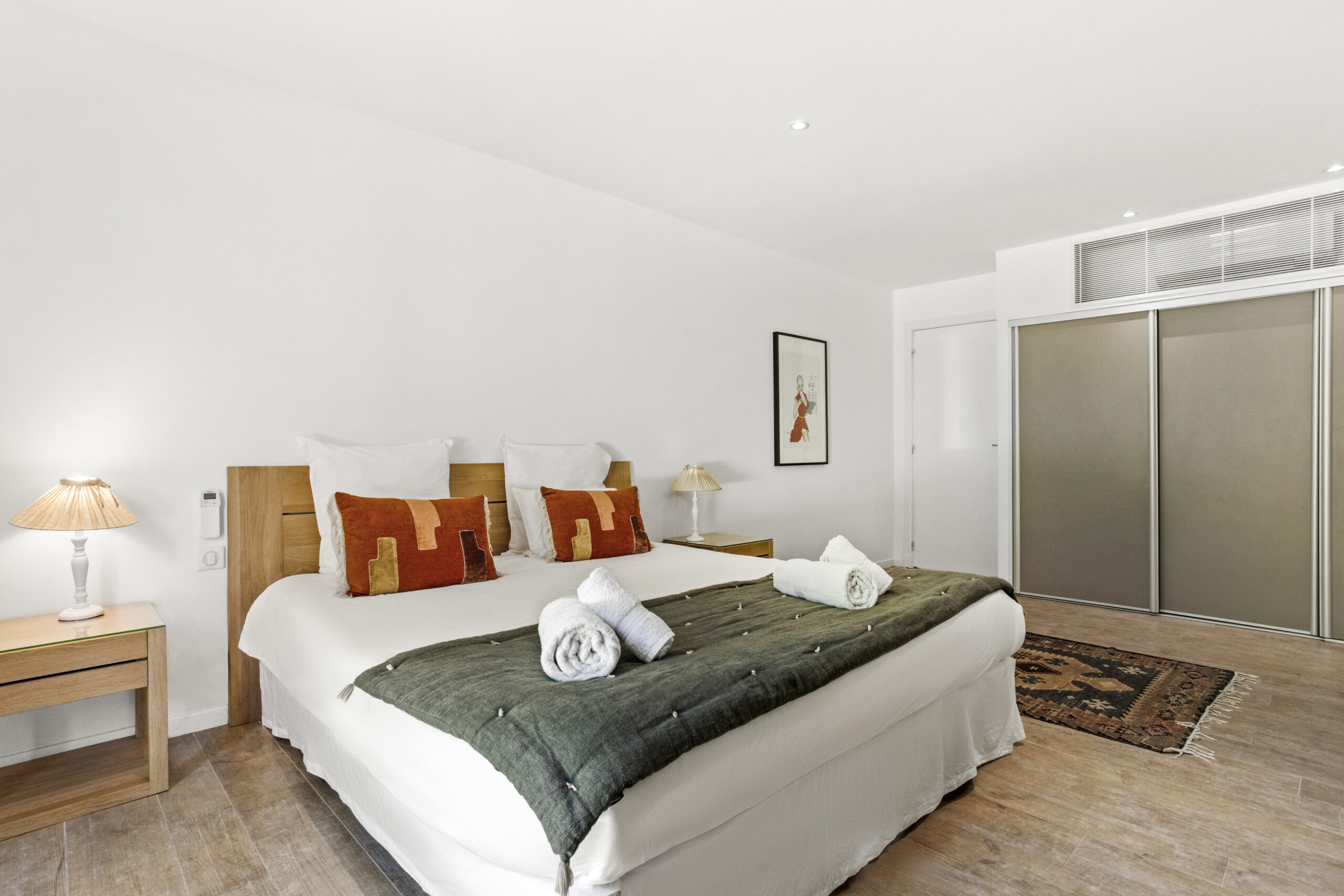 Sand suite bedroom at Villa Cycas featuring a king-size bed, warm earth tones and refined decor