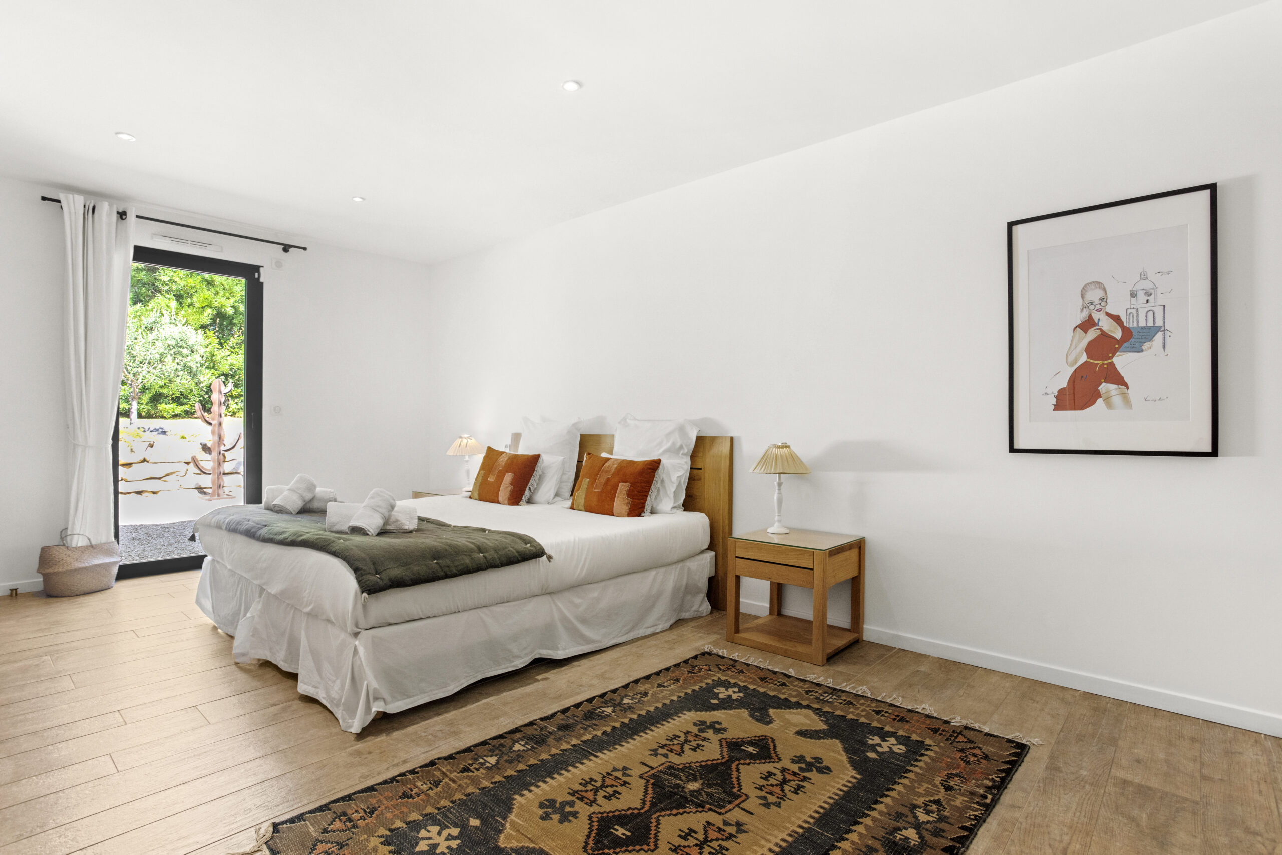Spacious sand suite bedroom at Villa Cycas with natural light and direct access to the outdoors
