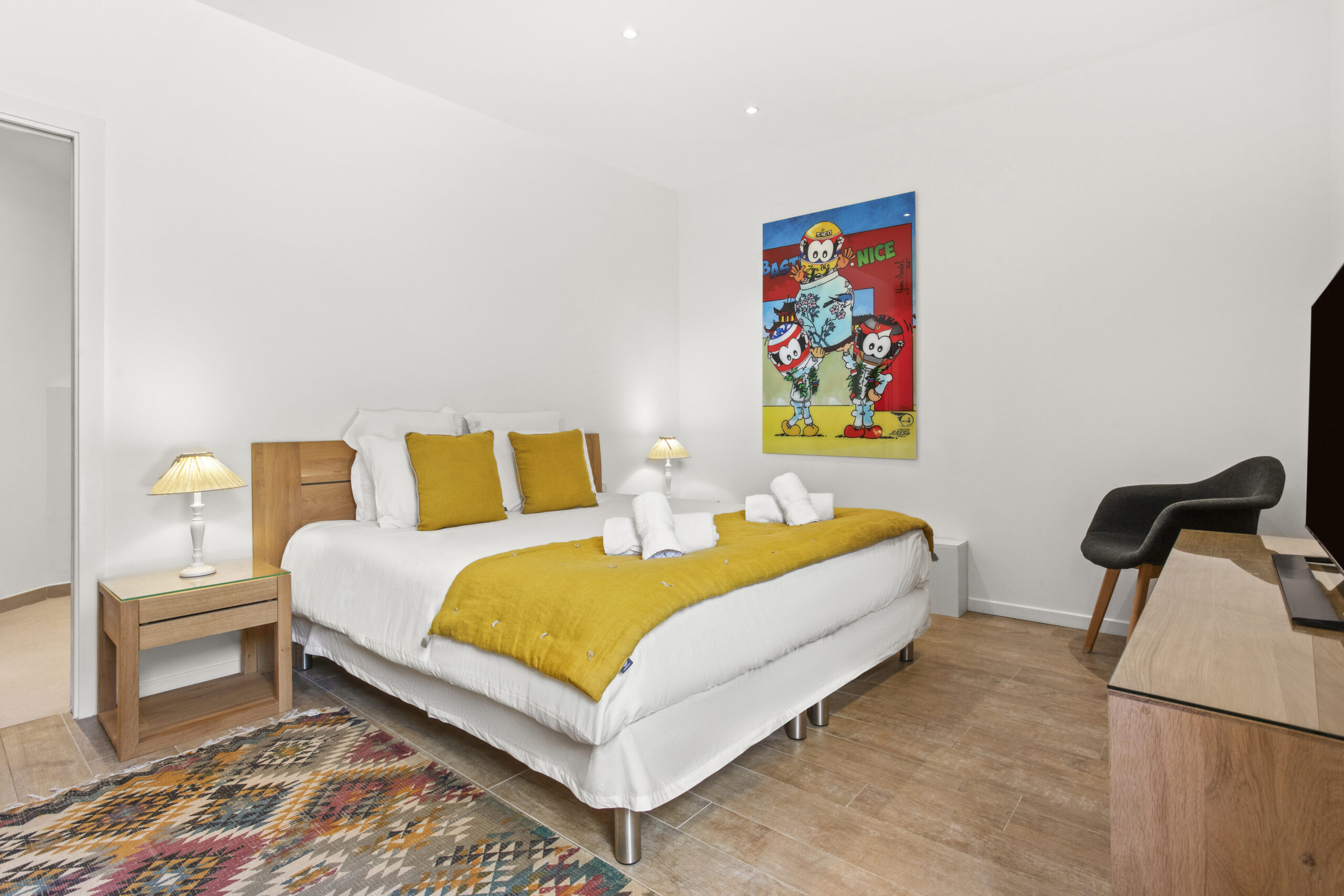 The Yellow Suite bedroom featuring a king-size bed, yellow accents and contemporary art